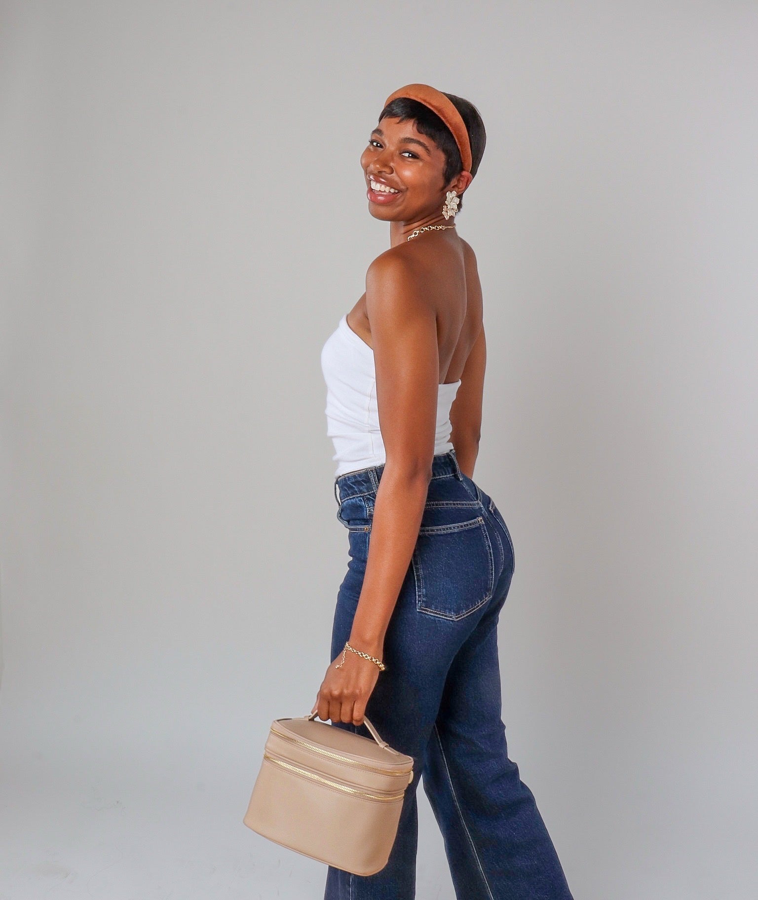 Beige vanity case carried by Black woman 