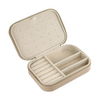 Spacious rectangular jewelry case for travel with compartments to keep necklaces, hoops, rings, and accessories organized